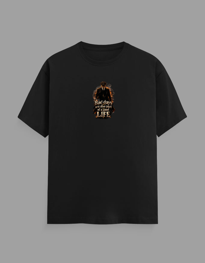 A black short-sleeve crewneck t-shirt with a graphic print on the chest depicting a cowboy silhouette and the text 'That day is over and my life' in a distressed font, shown against a solid gray background.