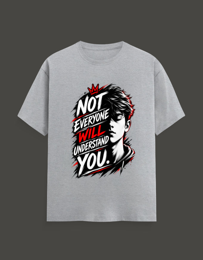 A light gray short-sleeve t-shirt with a bold graphic print on the front. The graphic features a stylized black and white portrait of a man's face with red hair details, overlaid with the text 'NOT EVERYONE WILL UNDERSTAND YOU.